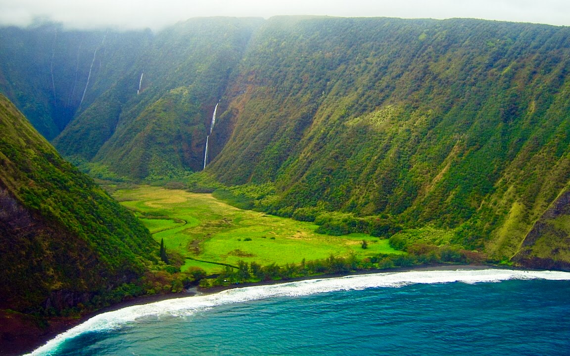 Aerial view of Waimanu Valley, waterfalls, and coastline