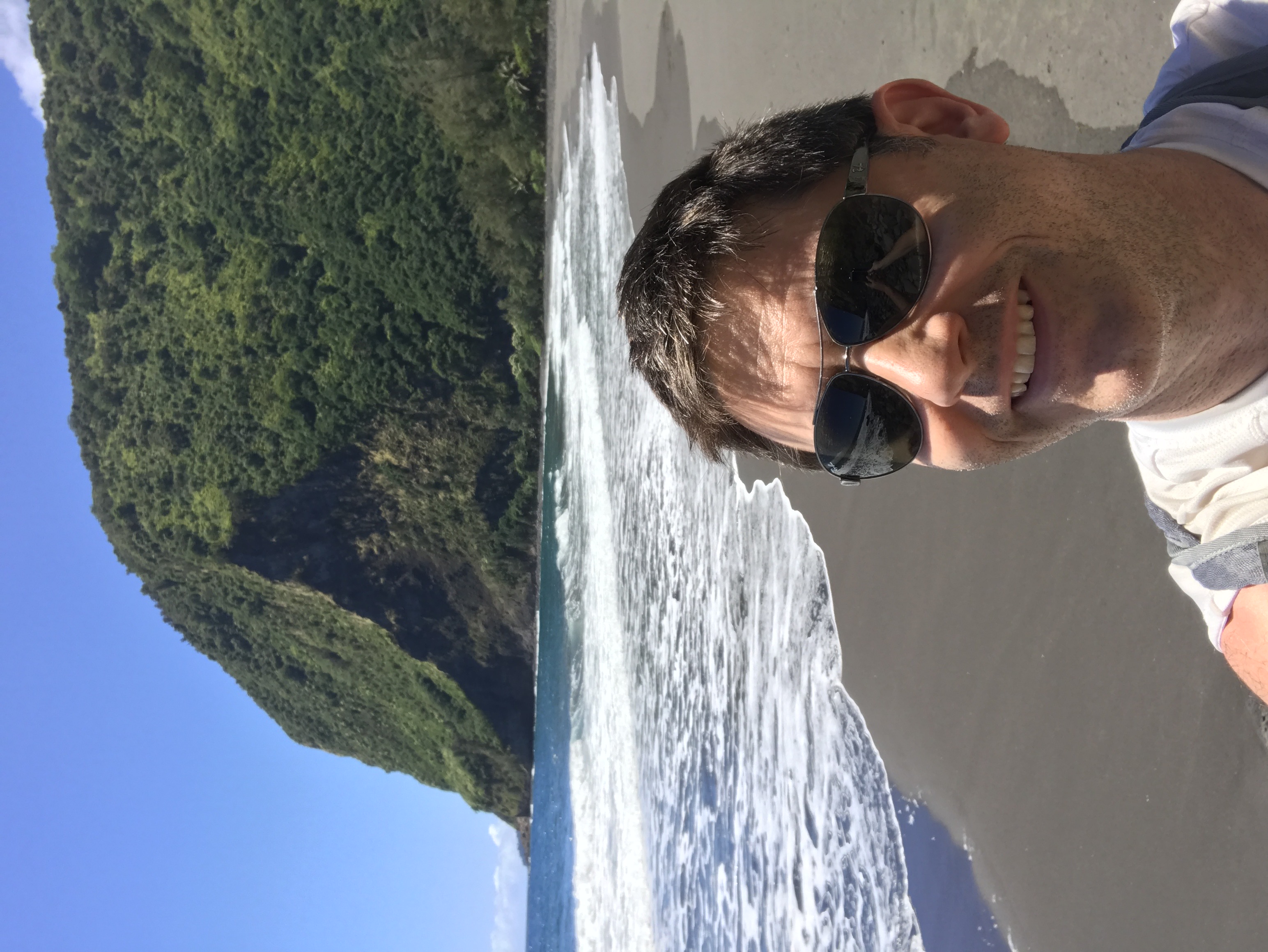 Conor on the black-sand beach at Waimanu