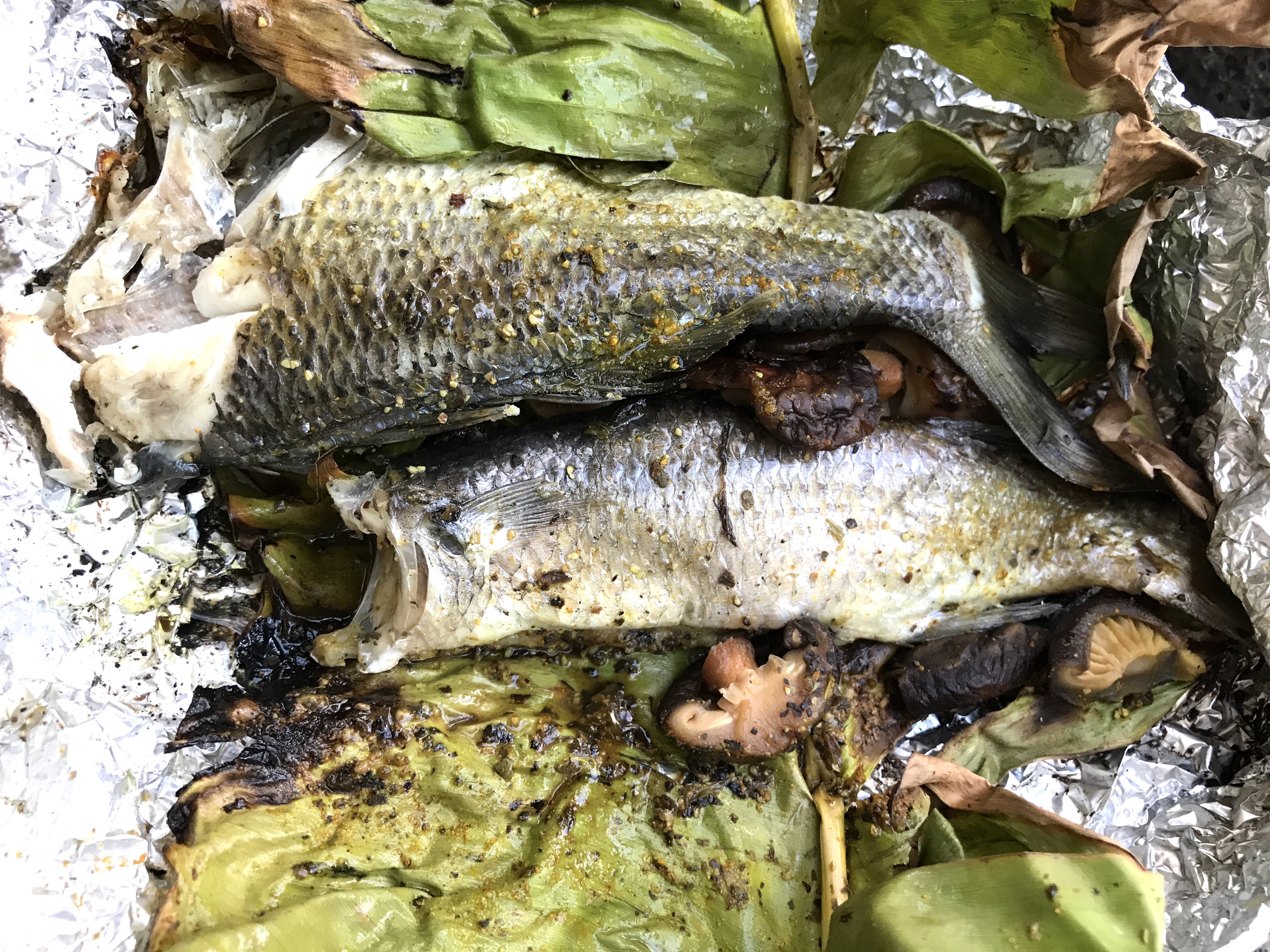 Fish and mushrooms cooked in banana leaves