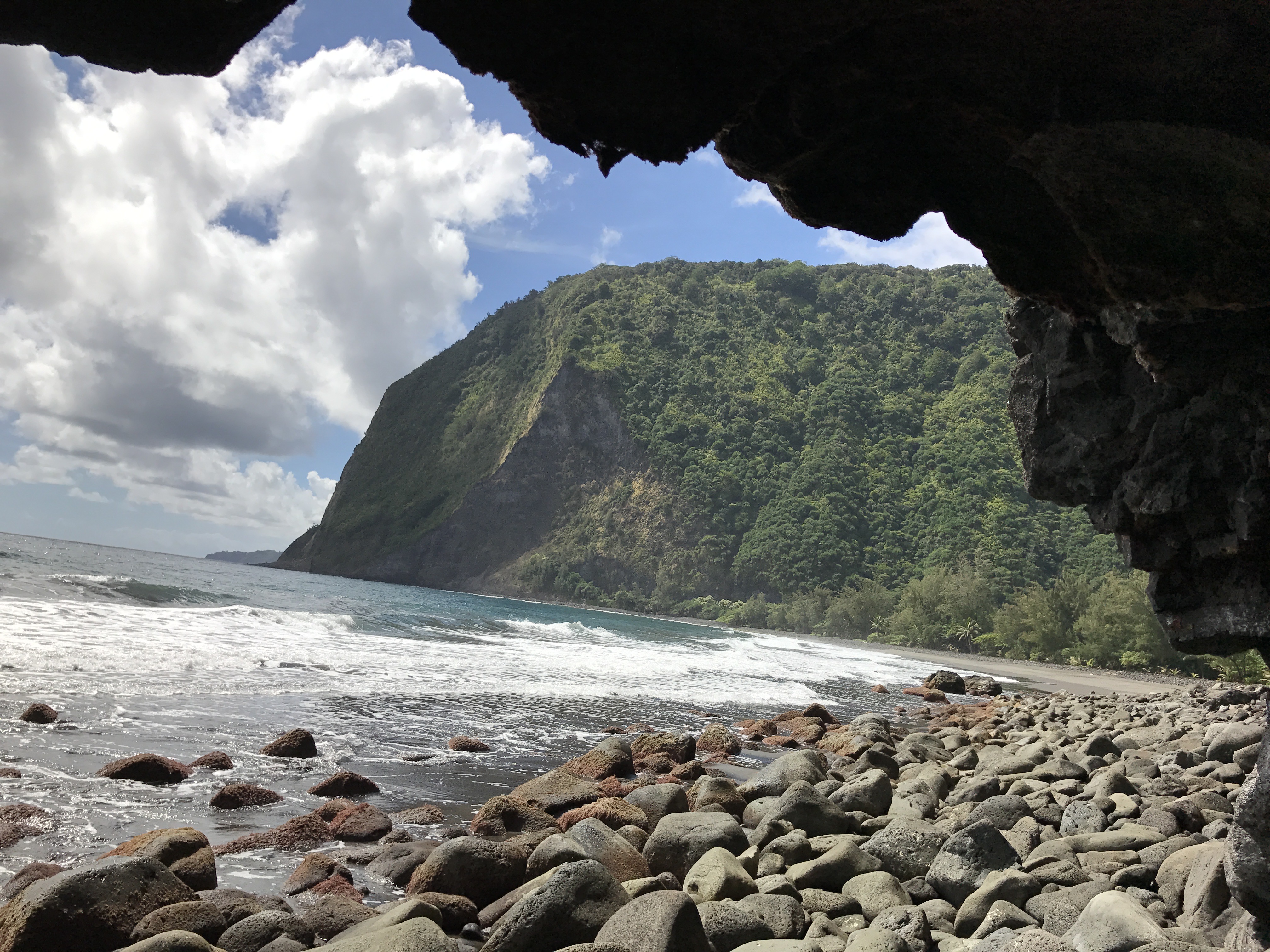 The Waimanu coastline framed by a sea cave