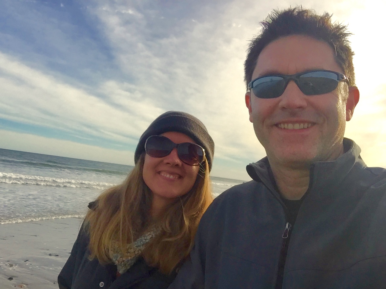 A couple taking a selfie on a beach