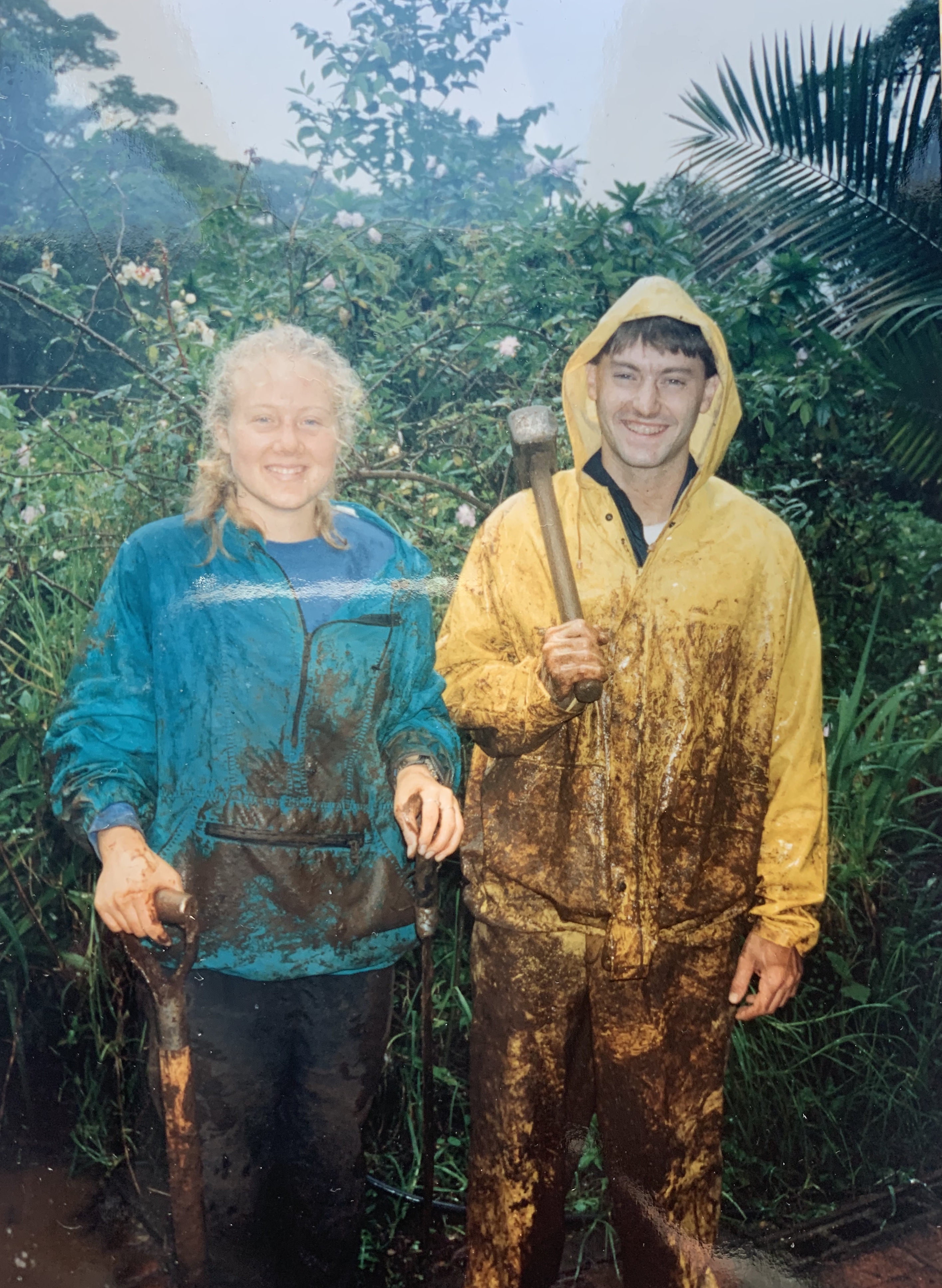 Two muddy hikers in the jungle after a storm
