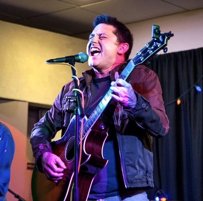 A musician performing live on stage